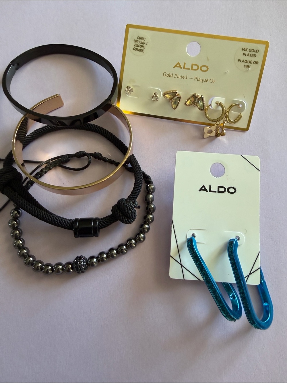 ALDO Black & Gold Bracelet Stack with Blue Hoop Earrings